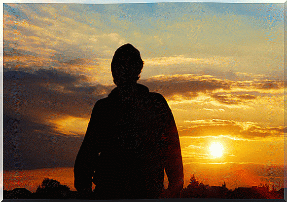 Person in front of sunrise