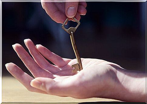 Person with key in hand