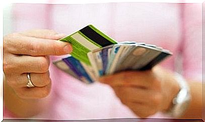 Person stands with different debit cards