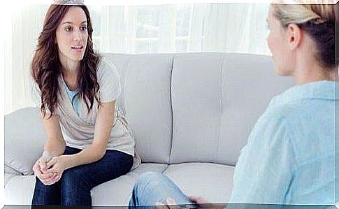 Woman on sofa with therapist