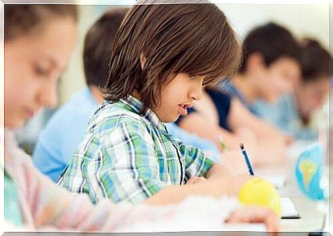 Boy writing with pencil