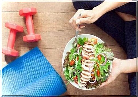 Person sitting on floor with a bowl of salad