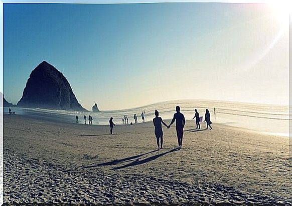 Beach filled with couples in the summer