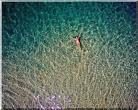 Woman floating alone in the sea