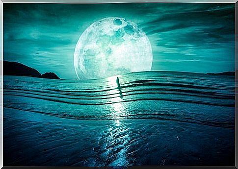 lady in the sea with giant moon in the background