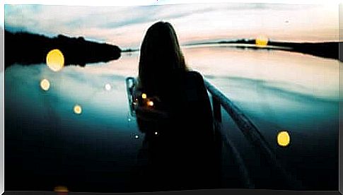 woman looking out on lake