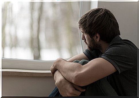 Man looking out window