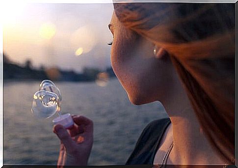 Woman blowing soap bubbles