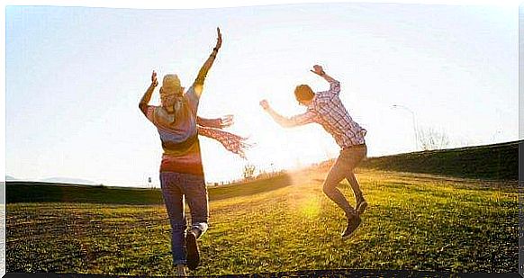 People dance in the sun on meadow