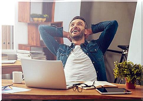 Smiling man in office has found joy at work