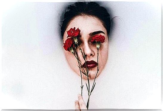 Woman with roses in front of eyes as symbol of emotional hangover