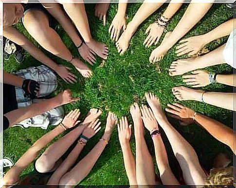 People sitting in circle on grass