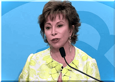 Isabel Allende speaks into a microphone