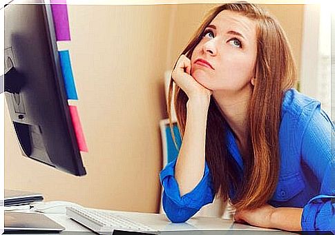 Woman getting bored at a computer