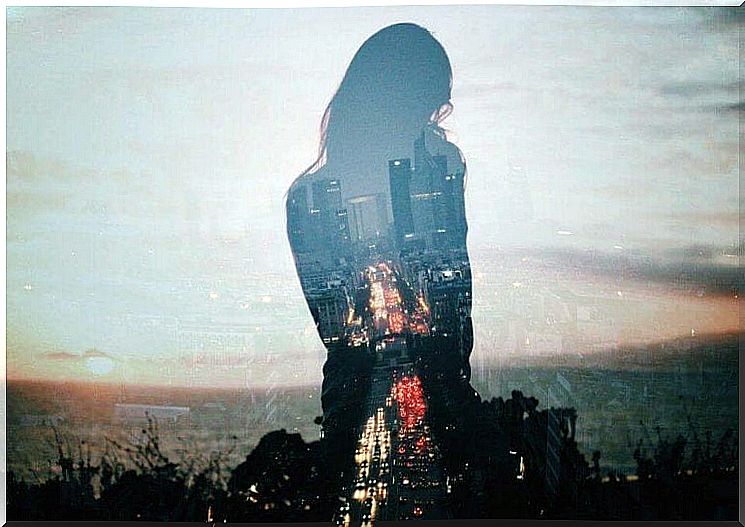 Woman's silhouette in front of big city