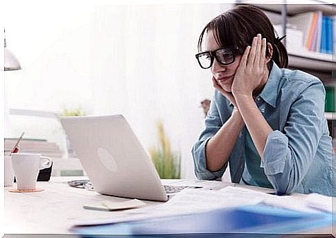 Tired woman in front of laptop