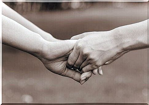 Individuals hold hands as togetherness promotes psychological well-being