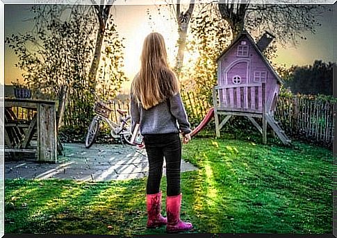 A girl in front of a magic playhouse