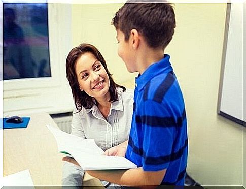 Student shows his homework to his teacher 