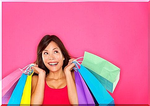 Woman smiling contentedly with many shopping bags