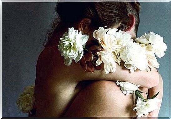 Naked couple wrapped in flowers