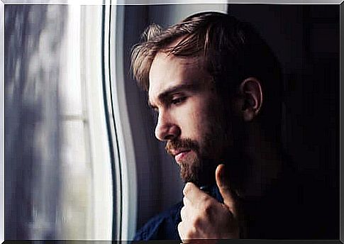 man looking out window