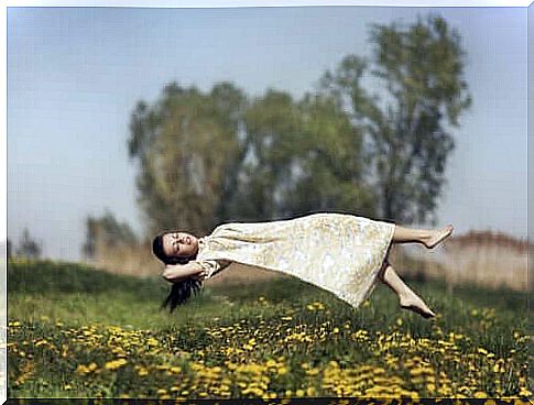 Woman floating on meadow experiences one of the different types of hallucinations